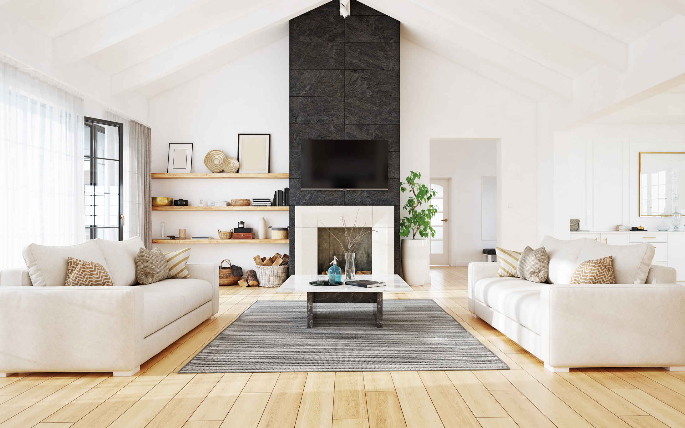 Bright modern living room interior with vaulted ceilings and a stone fireplace